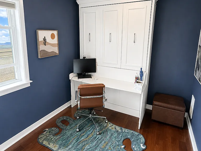Second bedroom shown as a home office with queen Murphy bed