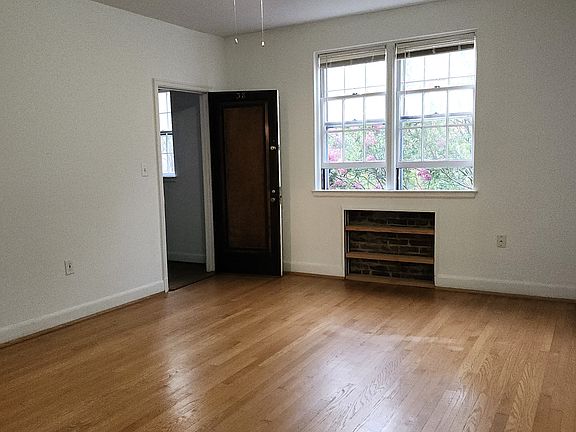 Front entry into living room with bookcase.