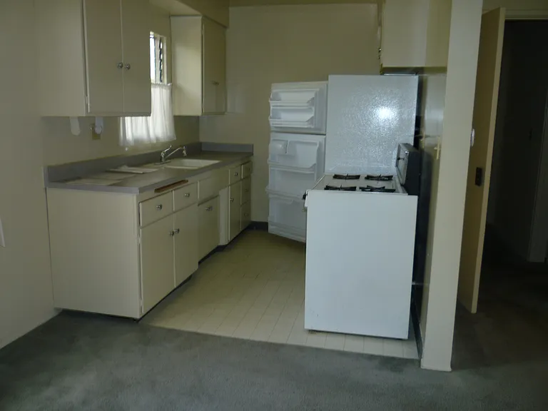 Kitchen including Stove/oven and refrigerator. Storage/cabinet shelves both sides