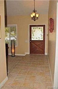 Tile entry with custom entry door with stained glass.