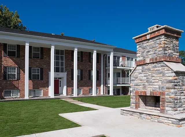 Relax by the outdoor stone fireplace in the beautiful courtyard at University Hills Apartments near the University of Toledo.