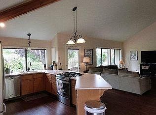 Family room view from kitchen. Windows face back yard.