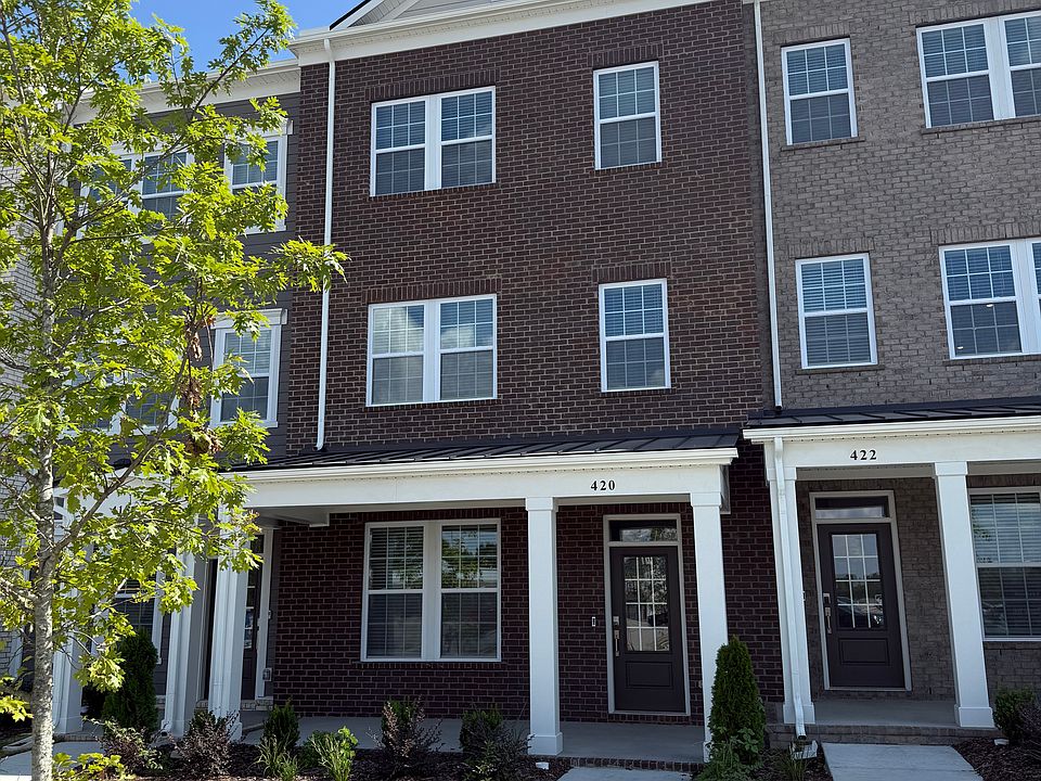 Front elevation. All landscaping taken care of! No yard maintenance required. Covered front porch!