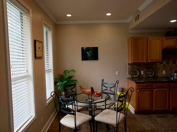 The breakfast room is readily accessible to the kitchen  and overlooks the courtyard where the pool is located.