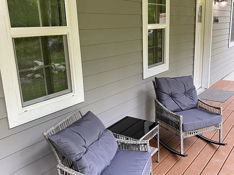 Outdoor rocking chairs on front porch.
