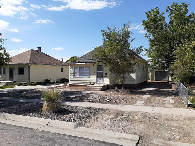 Large yard with a sizable driveway.