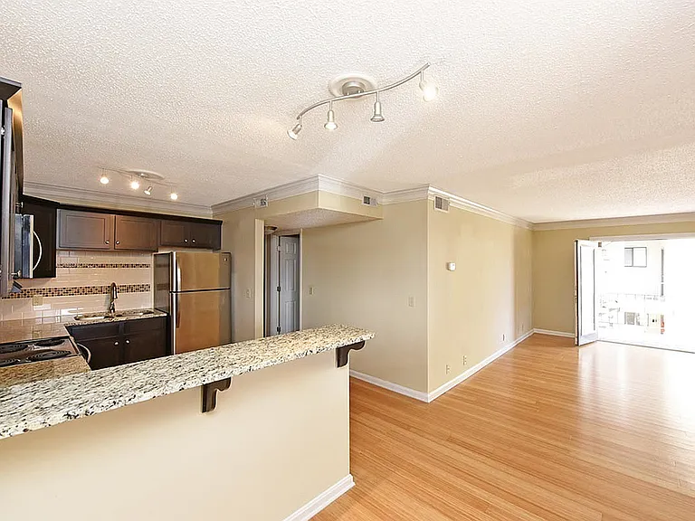 Step into modern elegance with this open-concept kitchen and living space.