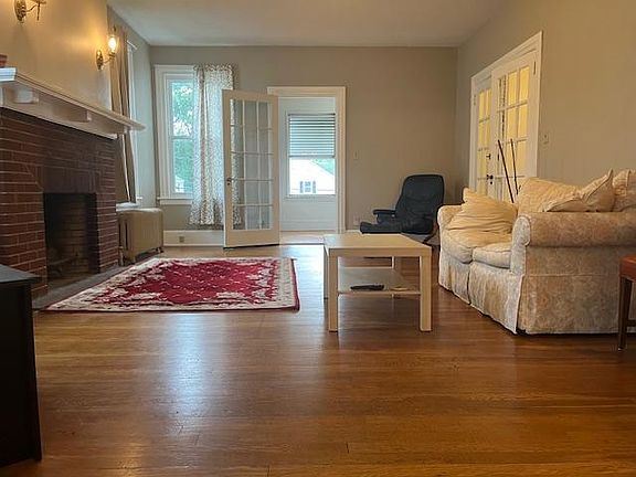 Living room with fireplace and entrance to 3 season sun porch