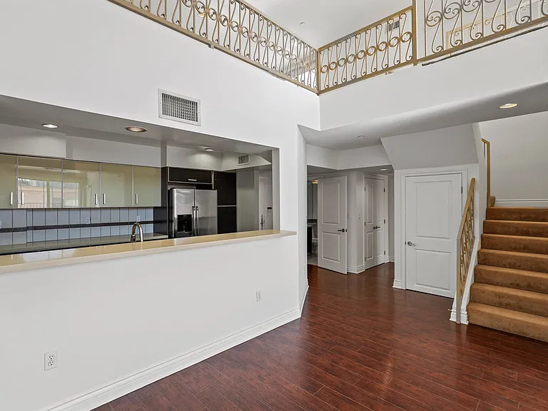 Open-Concept Kitchen and Staircase to Loft Space