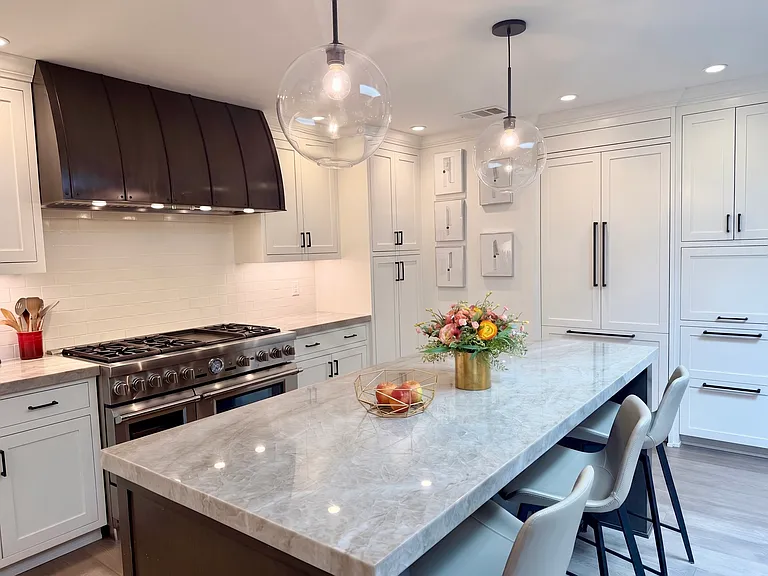Quartzite island and built-in custom cabinetry and 2-door fridge
