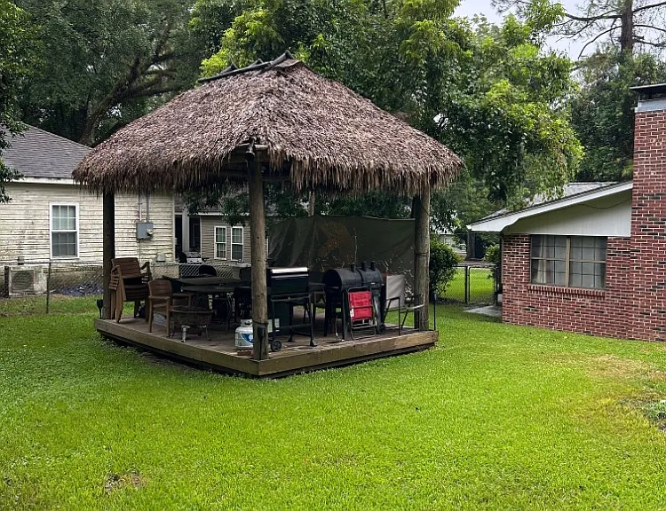 back yard with tiki hut grills