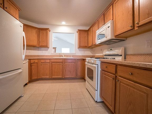 LARGE EAT-IN KITCHEN W/LOADS OF CABINETS, COUNTER TOPS, PANTRY CABINET W/BUILT IT STORAGE DRAWERS, CERAMIC TILE,  PLUS ALL APPLIANCES STAY!