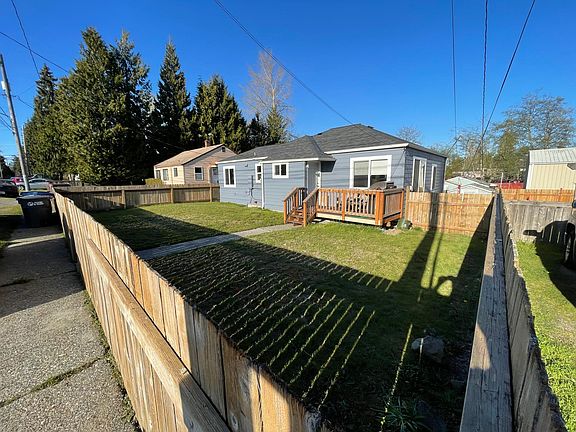 Fenced in yard with front porch.