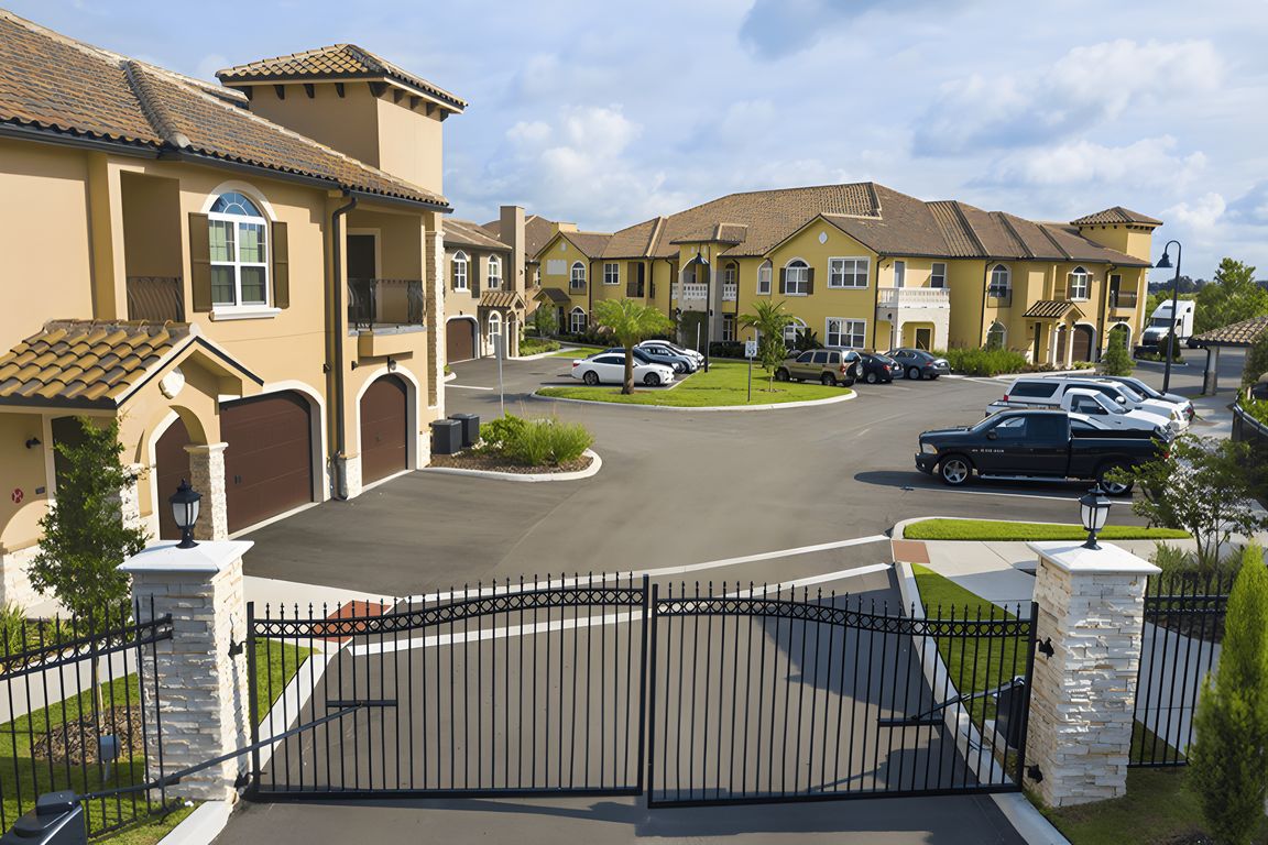 Gated entrance to Portofino at ChampionsGate with view of Mediterranean-style townhomes and landscaped drive.