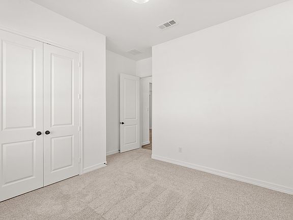 An additional view of the second bedroom and closet.