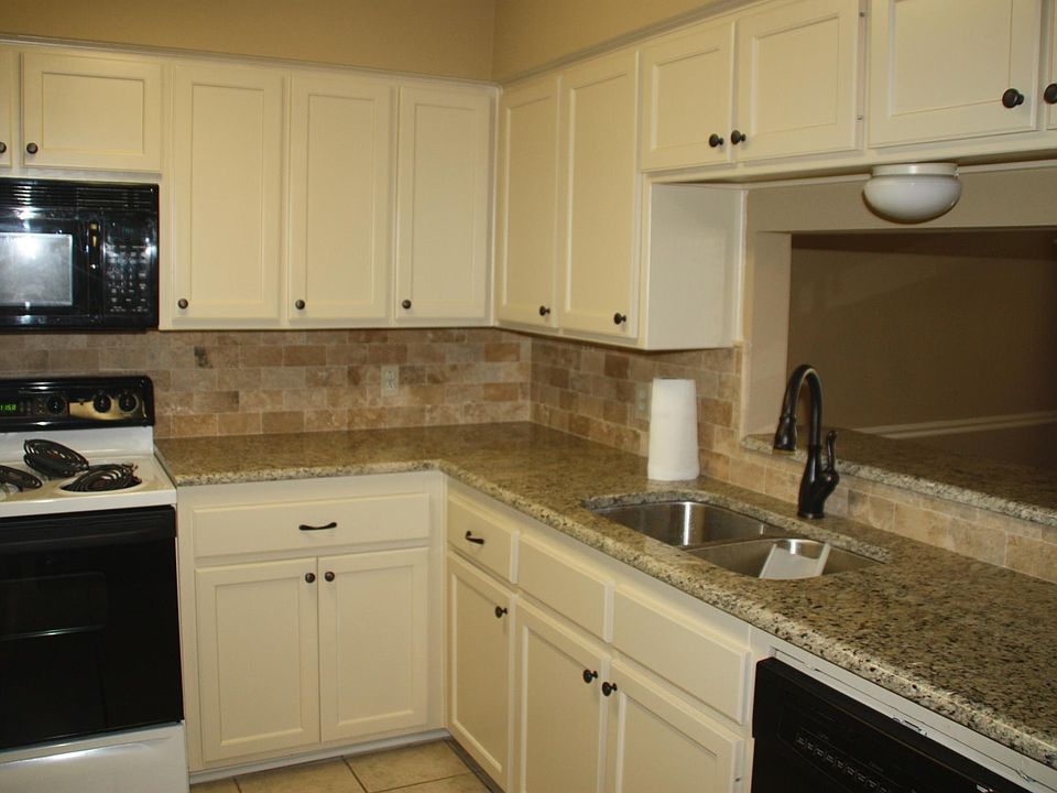 Updated kitchen with granite countertops and tumbled marble backsplash
