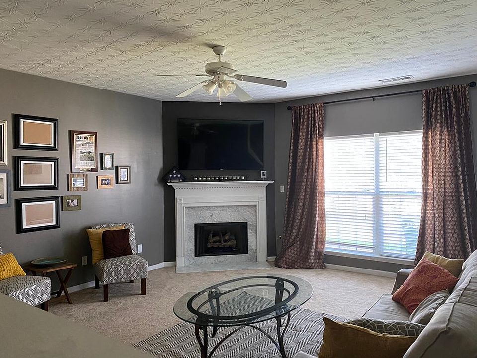 The spacious living room features a gas fireplace and spacious under the stair closet. Residents may access to the back patio, gazebo area, and walking path from the living room