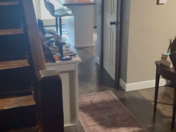 View from from entry, to the right is the living area (not in photo), Straight is kitchen/dining area. far door is large shared back deck. Up stairs is two Bdrs and full bath and a hallway closet.