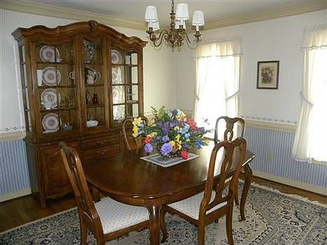 Formal Dining Room with hardwood floor, crown molding and chair rail
