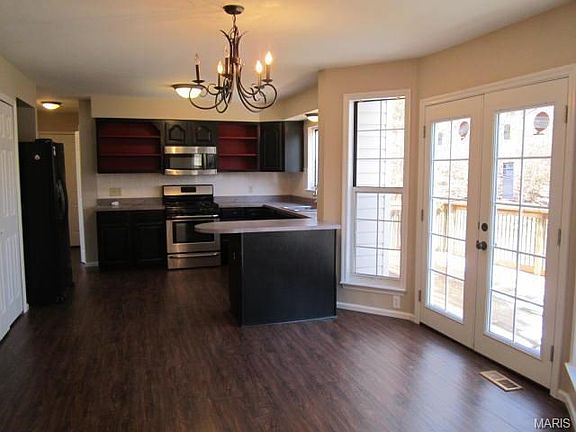 A view of the kitchen with stainless stove, microwave, and dishwasher.. Bay window with newly instal
