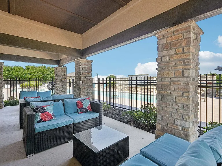 Comfortable lounge chairs by the sparkling pool at Arroyo Seco Villas.