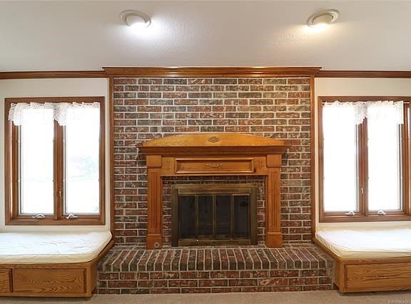Formal Living Room Fireplace wall with built-in storage benches