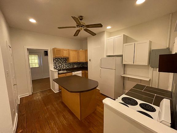 Kitchen from bottom of staircase and front door area