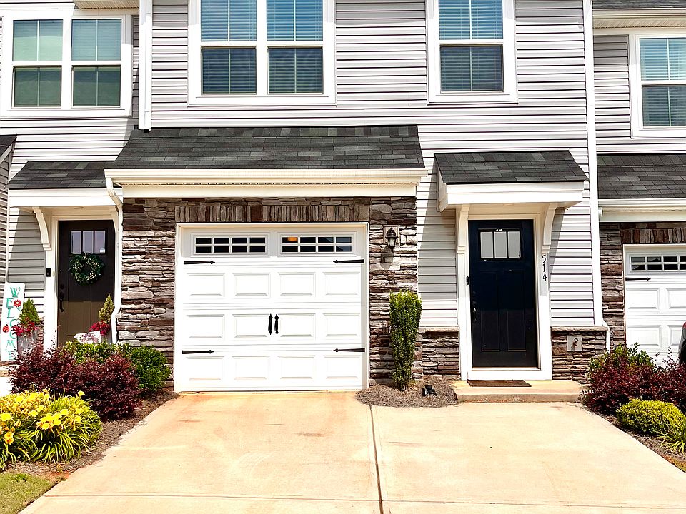 Front of house. One car garage with two car driveway. Camera doorbell and smart garage opener.