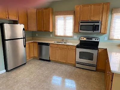 View of the kitchen. All stainless steel appliances. Lots of counter space and a built in pantry. Entrance to laundry room is across the room.