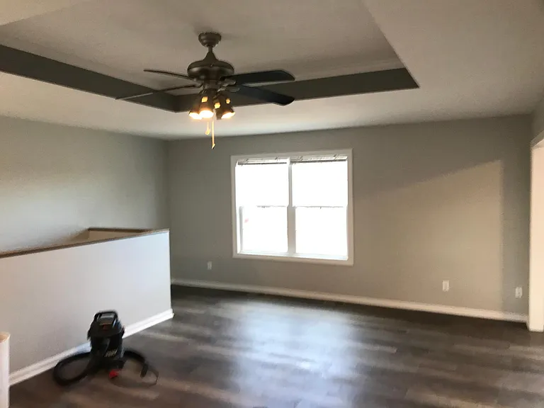 Large Living Room with ceiling bump up and ceiling fan.