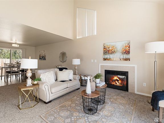 The luminous living room has a spacious feel with its lofty vaulted ceiling.