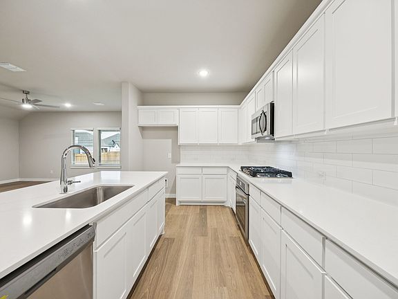 Kitchen in the Oscar home plan by Trophy Signature Homes - REPRESENTATIVE PHOTO