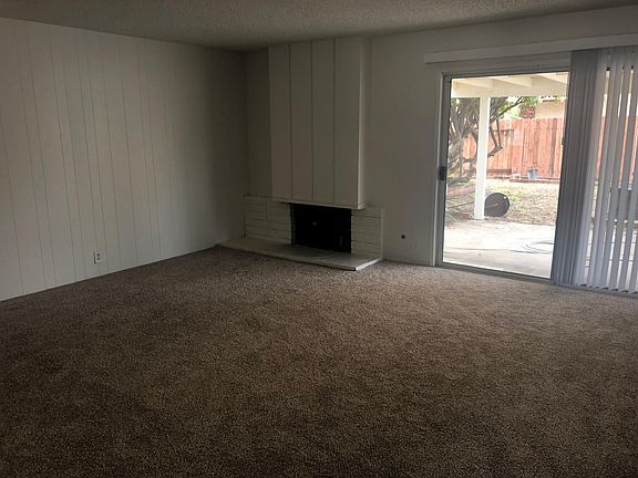 Dinning room with fireplace, leads out to the backyard.