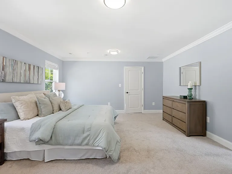 Master bedroom with sitting area, massive walk-in closet, and custom spa-like en-suite with soaking tub.