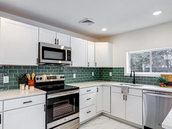 Beautiful backsplash, quartz counters, and all new appliances!