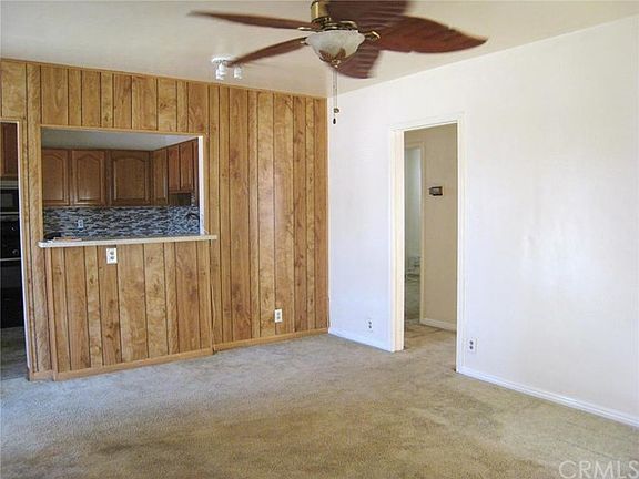 Another view of the living room... Hint:  There are refinished hardwood floors under the carpet in the living room...
