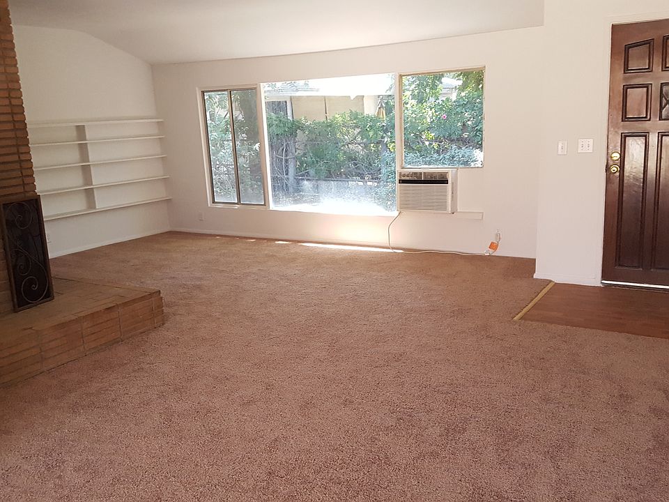 Open Living Room with wood burning fire place, entryway coat