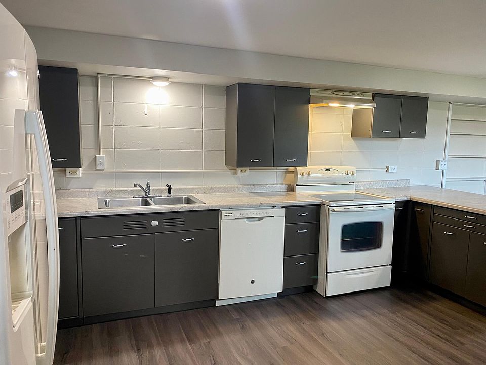 Kitchen View from apartment entrance- New flooring, counter tops & lighting. Updated appliances