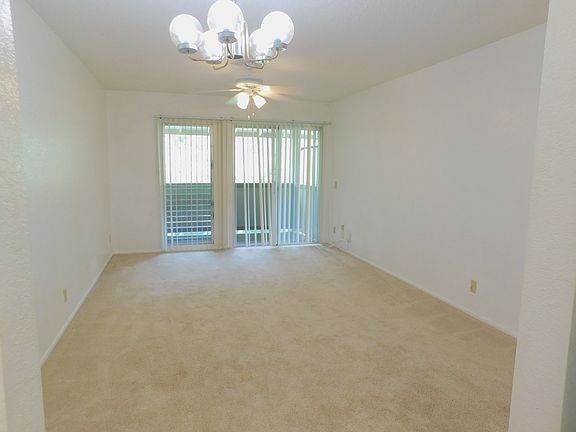 From the kitchen through the dining area and living area to the covered lanai with storage closet. Ceiling fan.