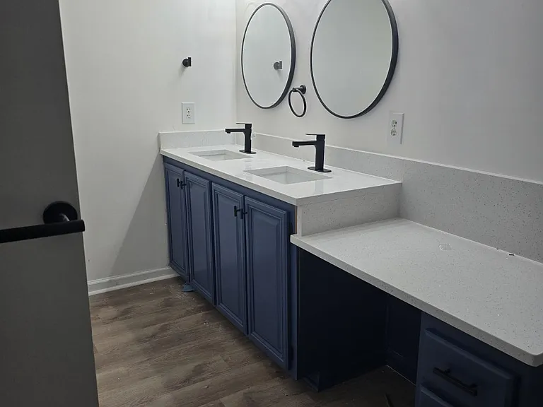 Upgraded master bathroom with Jacuzzi tub, separate shower, and his and her sink.