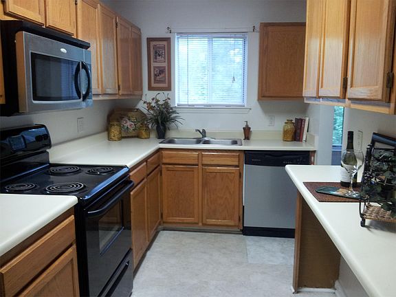 Full kitchen with range, microwave, refrigerator and dish wa