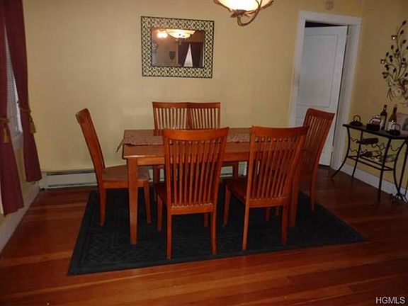 Formal dining room with hardwood flooring.