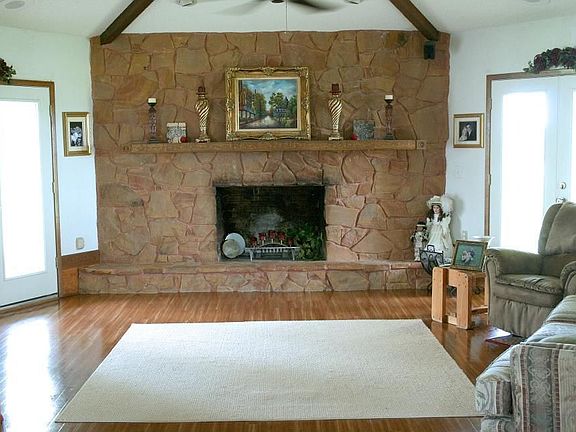 Light and airy living room with cedar beams and large fireplace
