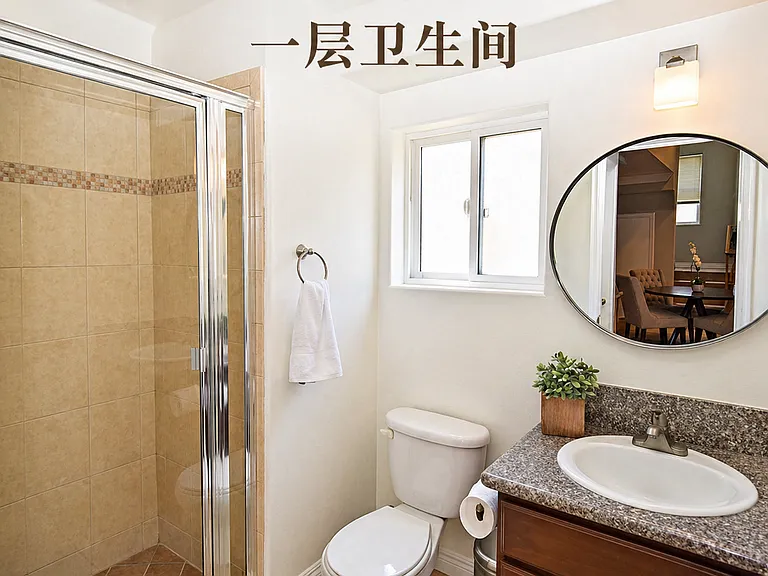 Conveniently located main-level full bathroom featuring a glass-enclosed walk-in shower and contemporary fixtures.