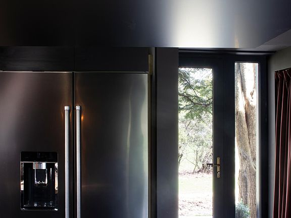 Open kitchen with bar and high-end appliances.