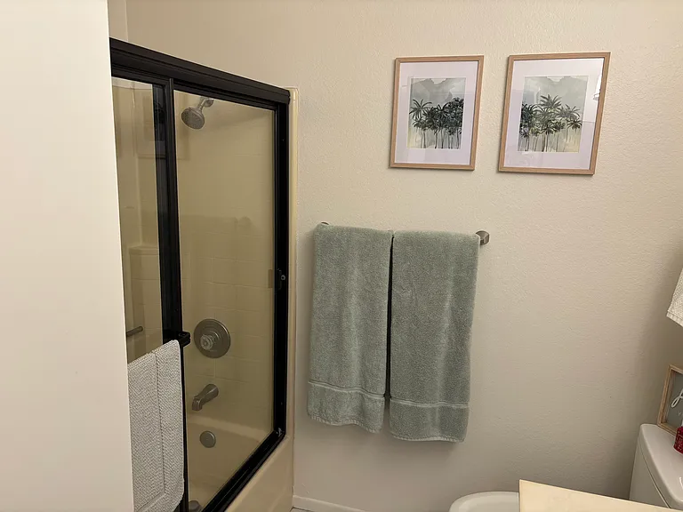Alternate view of upstairs bathroom with partial view of bathtub/shower enclosure