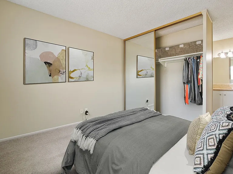 Bedroom with a mirrored closet doors