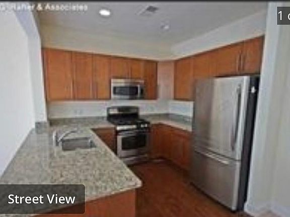 Open kitchen with granite counter tops and stainless steel appliances.