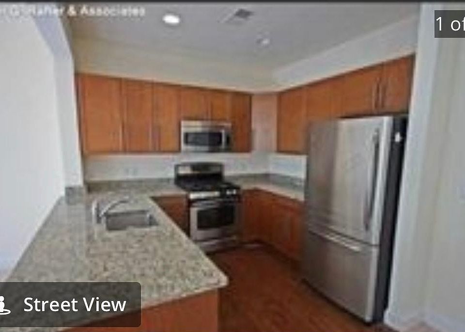 Open kitchen with granite counter tops and stainless steel appliances.