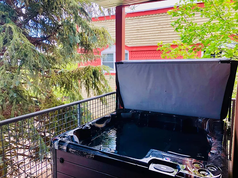 Private 5-person hot tub on a secluded deck, shielded by mature (30+ foot) spruce trees